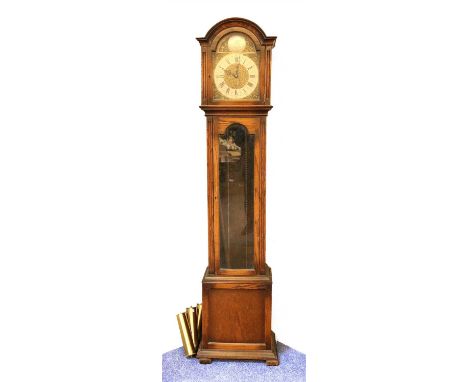 A 1930s oak longcase clock, with three train movement, chiming on eight bar gongs, with three brass weights, 194cm high