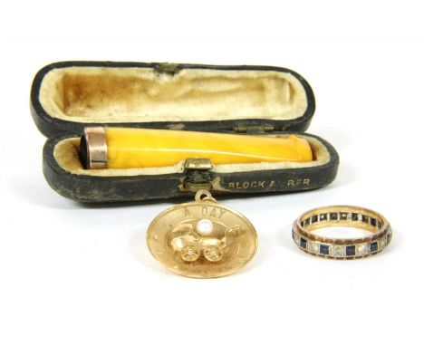 'A Day to Remember' charm with a pram , a synthetic spinel eternity ring marked 9ct, and a cased amber cheroot holder with 9c