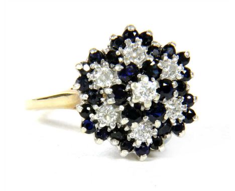 A 9ct gold diamond and sapphire four tier cluster ring, London 1979, 4.92g, size Q½