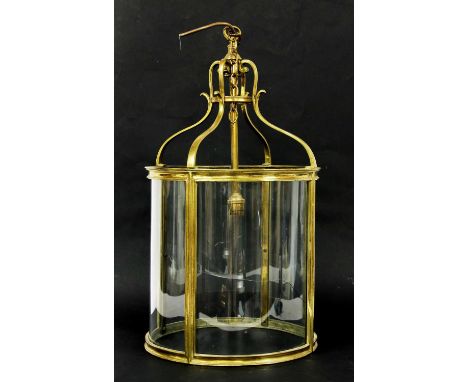 A Regency cylindrical brass hall lantern, having four quarter eliptical glazed panels (one cracked), 31cm diameter, 56cm high