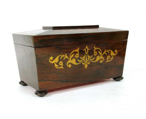 A Regency rosewood and brass inlaid sarcophagus tea caddy , the interior with twin lidded compartments (lacking bowl), on squ