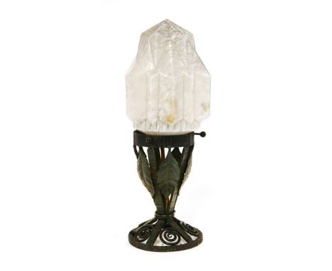 A French Art Deco wrought iron table lamp, with a mottled glass shade, the stand applied with leaves and scrollwork, 35cm hig