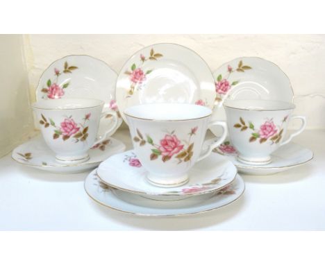 CHINESE PORCELAIN TEA SERVICE
with a white ground and gilt border decorated with roses, comprising cups, saucers and sandwich