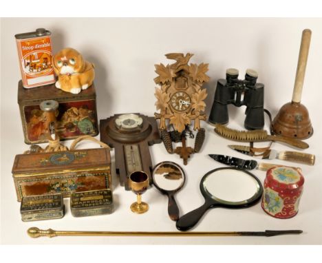 A cuckoo clock, c.1950s, with pendulum and weights, 20cm, together with advertising tins, barometer, skipping rope and others
