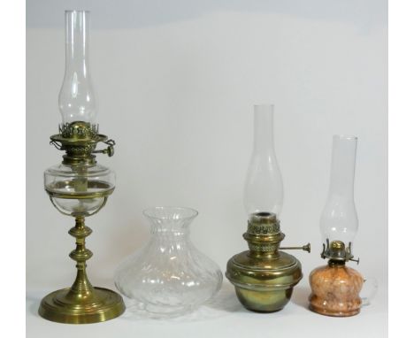 A Victorian oil lamp, solid brass with glass chimney, shade and reservoir, supported by brass fittings having a duplex twin w