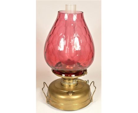 A Victorian foot warmer heat lamp circa 1890 presented with glass chimney and cranberry glass shade. 
