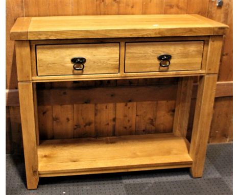 A modern solid oak hall table, twin drawers with cast brass drop handles and lower shelf.89 x 76 x 32cm