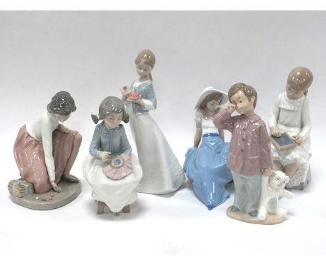 Nao figurines to include Girl playing marbles, A gift from the heart, Girl writing on blackboard, three others, tallest 23cm 