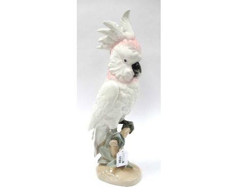 Royal Dux Ceramic Parrot, in pink and pastel tones, perched on naturalistic base, pink triangular applied plaque and stamped 