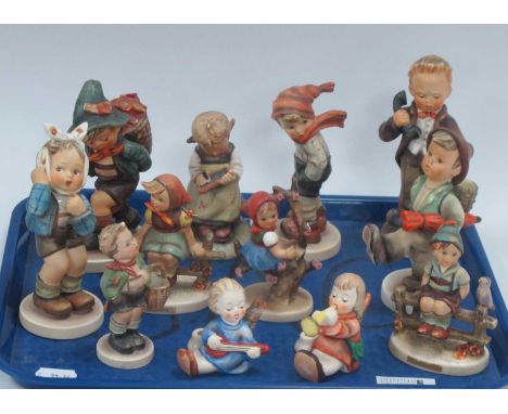 Twelve Goebel Figures, including a pair of candle holders, 'Girl with Toothache' and 'Hello' :- One TrayBoy with stick and ba