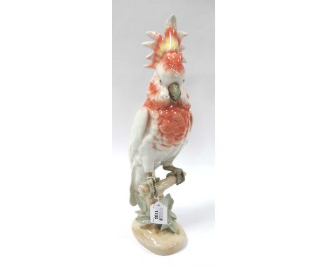 Royal Dux Ceramic Parrot, in red, yellow and pastel tones, perched on naturalistic base, pink triangular applied plaque and s