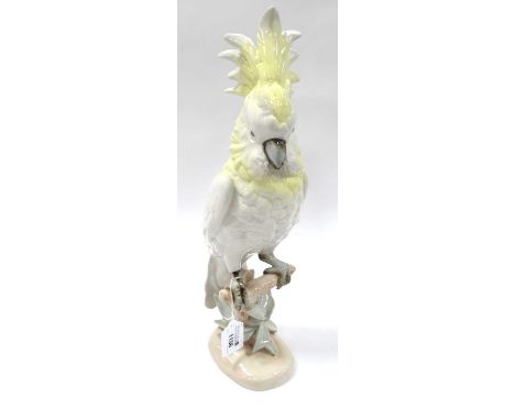 Royal Dux Ceramic Parrot, in yellow and pastel tones, perched on naturalistic base, pink triangular applied plaque and stampe