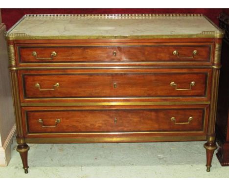 COMMODE, Directoire mahogany and gilt metal mounted with Carrara marble top and three quarter gallery above three long drawer