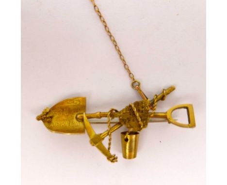 A vintage 9ct gold South African gold miner's brooch, featuring spade, pick and bucket, marked 'South Africa' to the spade, l