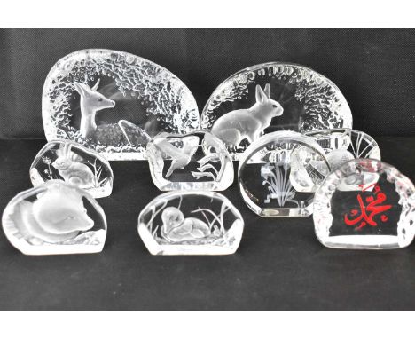 Nine modern moulded glass paperweights with scenes depicting animals in natural settings, including deer, rabbits, duck, seal