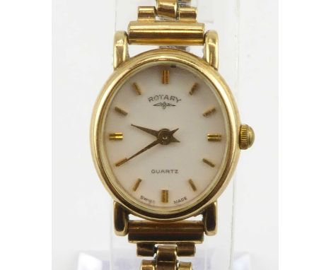ROTARY; a ladies' 9ct gold wristwatch, the white oval dial set with baton numerals, quartz movement, on a gold plated bracele