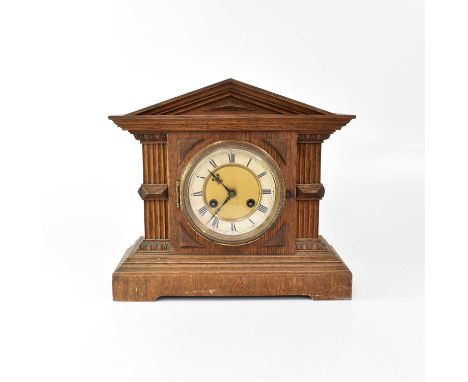 An early 20th century oak cased architectural mantel clock, with Junghans twin fusee movement striking on a gong, the enamell