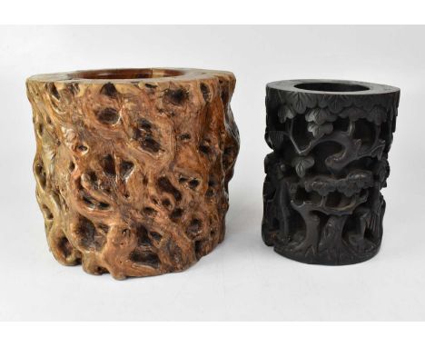 A carved wooden pot with figures amongst trees, height 18cm, and a knotted timber example (2).Condition Report: - The carved 