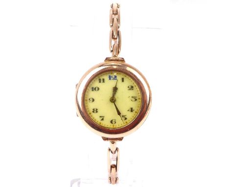 A ladies' vintage 9ct rose gold watch, the white enamelled dial set with Arabic numerals, crown wind movement, missing winder