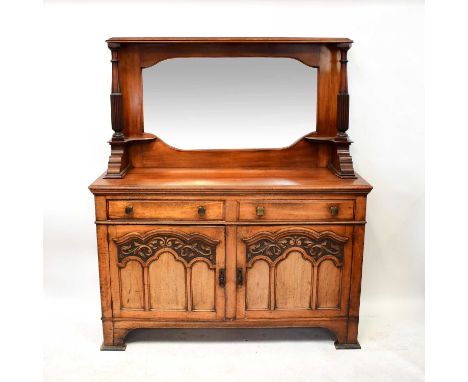A late 19th/early 20th century walnut mirror back sideboard, the shaped bevelled plate flanked by a pair of reeded columns, a