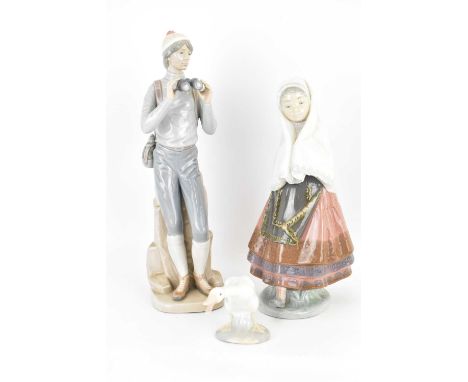 LLADRÓ; three porcelain figures comprising a mountaineer, height 33cm, girl with shawl, height 27cm and goose, height 8.5cm (
