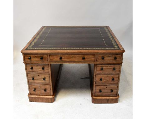 An early 20th century mahogany partners' desk of small proportions, with gilt tooled oxblood leather inset panel to the top a