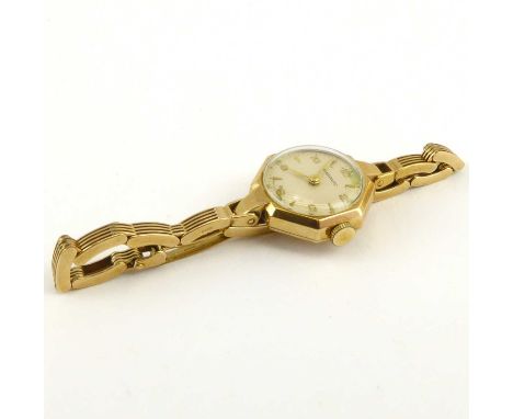 GARRARD; a ladies' 9ct gold wristwatch, the circular silvered dial set with Arabic and baton numerals, with outer minute trac