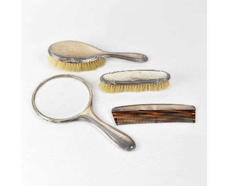 A hallmarked silver dressing table set and comb, W G Southers, various dates (4).