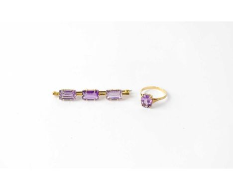 A 9ct gold ring set with oval amethyst in claw fittings, together with a 9ct bar brooch set with three emerald cut amethyst i