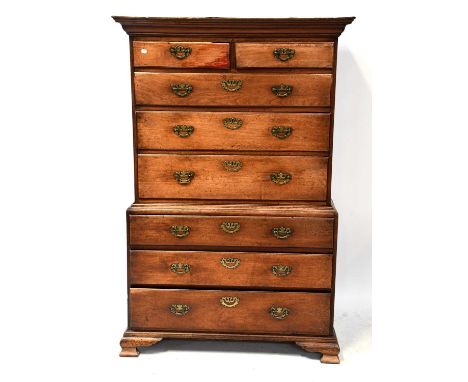 A Georgian mahogany chest-on-chest, the moulded cornice above two short drawers and three long graduated drawers, above a bas