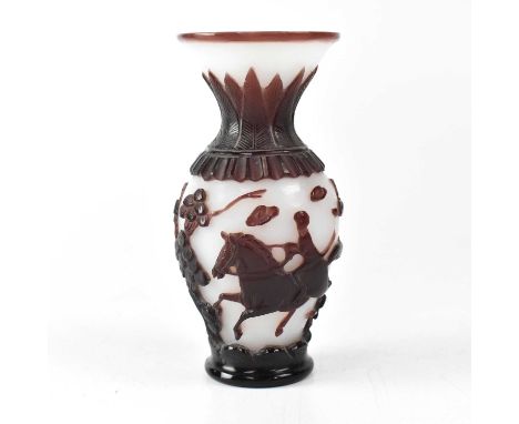 A Chinese Peking carved cameo glass vase in wine red and white, depicting riders and trees, incised seal mark to base, height