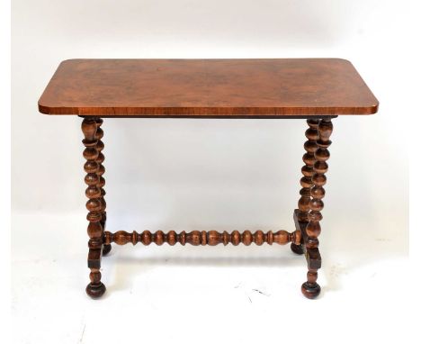 A late 19th/early 20th century walnut side table with bobbin turned supports, 67 x 90 x 44cm.