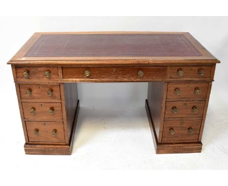 An Edwardian mahogany nine-drawer twin pedestal desk, with tooled oxblood leather inset panel above frieze of one long and tw