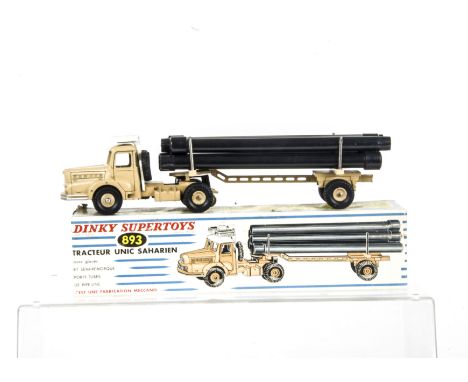 A French Dinky Toys 893 Unic Sahara Pipe Transporter, beige body, white roof, six black plastic pipes, in original box, VG, b