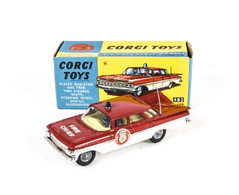 A Corgi Toys 482 Chevrolet Fire Chief, red over white body, blue light, yellow interior, grey aerial, round labels, spun hubs