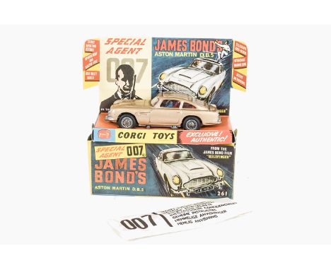 A Corgi Toys 261 James Bond's Aston Martin D.B.5, gold body, red interior, wire wheels, Bandit figure, in original box with d