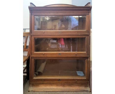 An Edwardian / early 20th century oak Lebus stacking lawyers bookcase cabinet having 3 sections with lit up glass fronts. The