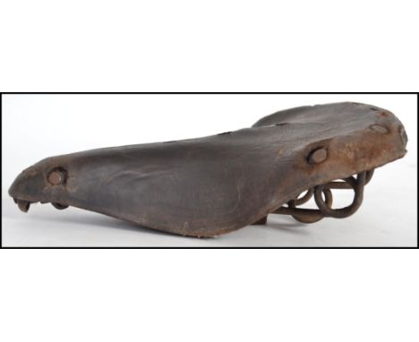 A vintage early 20th century Brooks leather bicycle seat having notation to side with spring work underneath.&nbsp;