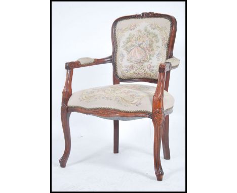 A 20th century French tapestry upholstered fauteuil armchair. The reeded mahogany frame with shaped elbow rests.&nbsp;Measure