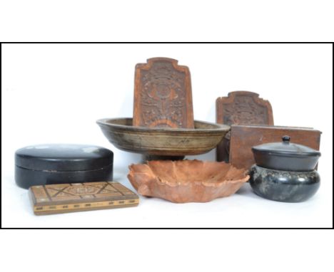 A good collection of vintage wooden and treen wares to include a turned wood bowl on tapering base, ebony lidded pots, a fant