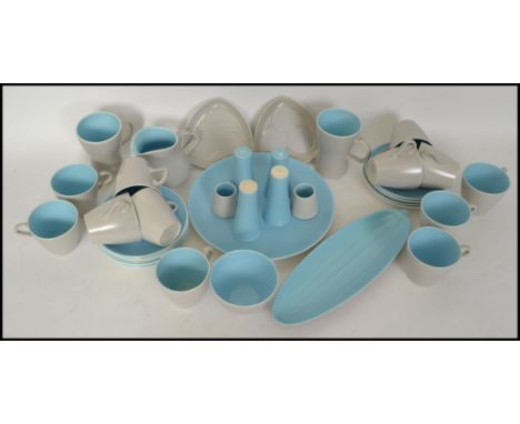 A retro mid century two tone vintage Poole Pottery part dinner and tea service being stamped to the back, the set comprising 