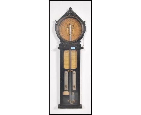 A carved oak Royal Polytechnic Barometer Joseph Davis &amp; Co, London, circa 1885. With foliate carved gabled pediment above