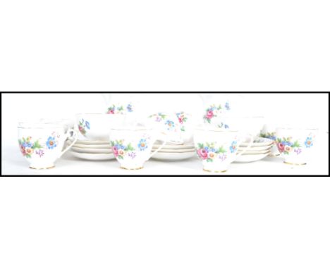 A Royal Crafton 10 person floral tea service consisting of 10 cups, saucers, side plates, 2 creamers and sugar bowls.