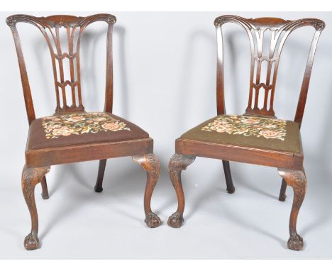 A pair of 19th century mahogany dining chairs with pierced splats, drop in tapestry seats with carved cabriole legs with ball