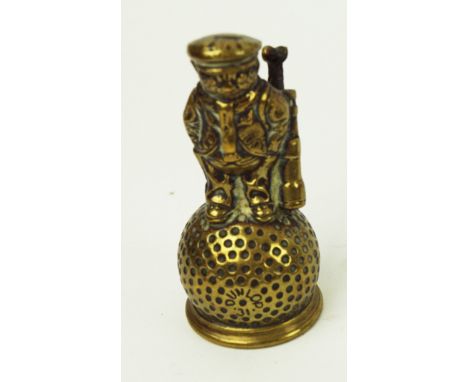 A 'Dunlop Man' hand bell, the clapper stamped 'Harcourt', 9cm high