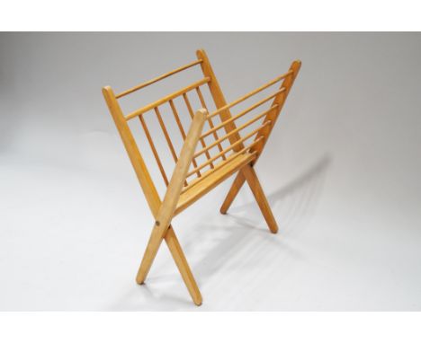 A 1970's floor standing magazine rack, with turned spindles, 53.5cm high x 74cm wide