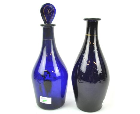 A Bristol Blue glass brandy decanter and stopper, 23.5cm high and a matching rum example, (no stopper)