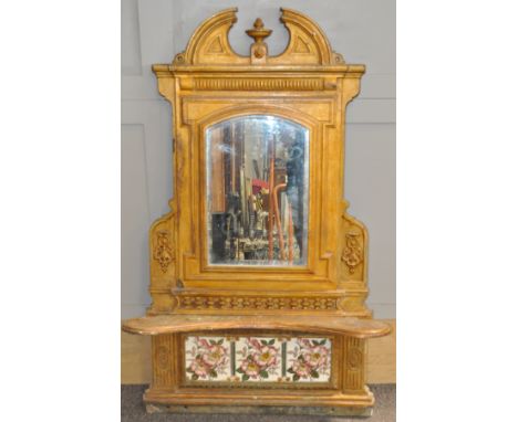 A Victorian cast iron over-mantel mirror, of architectural form, surmounted with a broken pediment and urn above an arched re