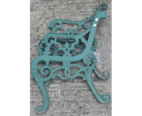 Two pairs of cast iron bench ends, of plain form, overall 78cm, together with another pair with lion mask terminals to the ar