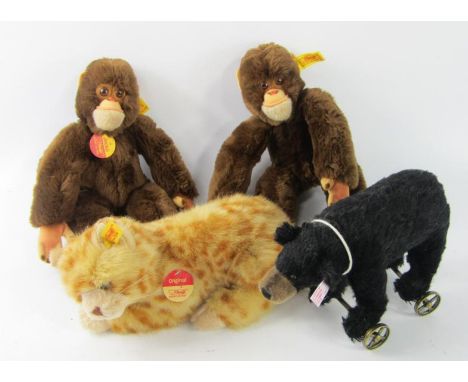 A Steiff cat, two Jacko monkeys and a bear on wheels. (4)